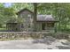 Log cabin home with stone wall and landscaping at 2705 S 975 E, Zionsville, IN 46077