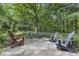 Stone patio with seating area, surrounded by lush greenery at 2705 S 975 E, Zionsville, IN 46077