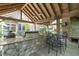 Lush outdoor kitchen with granite countertops, built-in grill, and stone fireplace at 2705 S 975 E, Zionsville, IN 46077