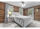 Serene bedroom with white bed frame and log cabin walls at 2705 S 975 E, Zionsville, IN 46077