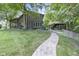 Beautiful log home exterior with stone accents, a large yard, and a winding path at 2705 S 975 E, Zionsville, IN 46077