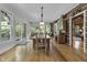 Sun-drenched dining room with a large wooden table and numerous chairs at 2705 S 975 E, Zionsville, IN 46077