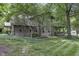 Log cabin home with lush landscaping and stone accents at 2705 S 975 E, Zionsville, IN 46077