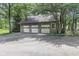 Three-car garage with stone accents and large doors at 2705 S 975 E, Zionsville, IN 46077