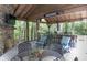 Relaxing outdoor kitchen with seating area, fireplace, and wooded views at 2705 S 975 E, Zionsville, IN 46077
