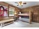 Charming bedroom with bunk beds, log cabin walls, and a playful atmosphere at 2705 S 975 E, Zionsville, IN 46077