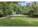 Inviting in-ground pool surrounded by lush landscaping and a private wooded backdrop at 2705 S 975 E, Zionsville, IN 46077