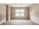 Empty bedroom with neutral walls and carpet, featuring a window with blinds at 8235 Ridge Valley Ct, Indianapolis, IN 46278