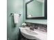 Charming bathroom with a teal wall and dark framed mirror at 8235 Ridge Valley Ct, Indianapolis, IN 46278