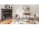 Elegant living room with a fireplace, statement art, and comfortable seating at 8235 Ridge Valley Ct, Indianapolis, IN 46278
