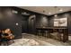 Basement bar with live-edge wood countertop and gold bar stools at 8235 Ridge Valley Ct, Indianapolis, IN 46278