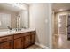 Bathroom with vanity, mirror, and access to another room at 8235 Ridge Valley Ct, Indianapolis, IN 46278