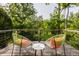 Deck overlooking a wooded area with two chairs and a small table at 8235 Ridge Valley Ct, Indianapolis, IN 46278