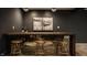 Live-edge wood bar in a finished basement, featuring gold bar stools at 8235 Ridge Valley Ct, Indianapolis, IN 46278
