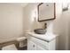 Modern bathroom with stone sink and wooden framed mirror at 8235 Ridge Valley Ct, Indianapolis, IN 46278