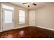 Empty bedroom with hardwood floors, white door, and window at 8235 Ridge Valley Ct, Indianapolis, IN 46278