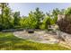 Landscaped backyard with fire pit and retaining walls at 8235 Ridge Valley Ct, Indianapolis, IN 46278