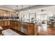 Modern kitchen with light wood cabinets, granite counters, and stainless steel appliances at 8235 Ridge Valley Ct, Indianapolis, IN 46278
