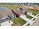 Aerial view of homes with red and gray siding, two-car garages, and a pond at 233 Marble Wood Dr, Danville, IN 46122