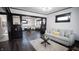 Open concept living room with hardwood floors, dining area, and built-in shelving at 526 N Emerson Ave, Indianapolis, IN 46219