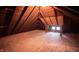 Unfinished attic space with wood flooring and exposed beams at 526 N Emerson Ave, Indianapolis, IN 46219