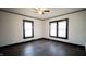 Simple bedroom with hardwood floors and two windows at 526 N Emerson Ave, Indianapolis, IN 46219