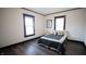 Bedroom with a bed, dark hardwood floors and windows at 526 N Emerson Ave, Indianapolis, IN 46219