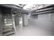 Unfinished basement with a furnace and wooden stairs at 526 N Emerson Ave, Indianapolis, IN 46219
