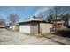 Tan colored garage with a white door at 526 N Emerson Ave, Indianapolis, IN 46219