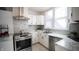 Modern kitchen with stainless steel appliances and marble countertops at 526 N Emerson Ave, Indianapolis, IN 46219