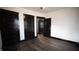 Bedroom with dark hardwood floors and multiple doors at 526 N Emerson Ave, Indianapolis, IN 46219