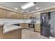 Modern kitchen with wood cabinets, stainless steel appliances, and light flooring at 556 Silver Fox Ct, Indianapolis, IN 46217