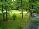 Landscaped yard and trees bordering a paved road at 8157 Center Lake Rd, Nineveh, IN 46164
