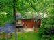 House nestled in a wooded area, showcasing the back elevation at 8157 Center Lake Rd, Nineveh, IN 46164