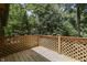 Wooden deck with lattice railings overlooking a wooded area at 8157 Center Lake Rd, Nineveh, IN 46164