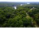 Aerial view of a lakefront property surrounded by lush forest at 8157 Center Lake Rd, Nineveh, IN 46164