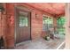 Cozy front porch with rocking chair and wooden walls at 8157 Center Lake Rd, Nineveh, IN 46164