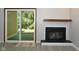 Modern fireplace with wood mantel and sliding glass door at 5188 Fairway Dr, Avon, IN 46123