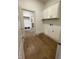 Laundry room with built-in cabinets and wood-look tile floor at 11327 Briargate Dr, Fishers, IN 46040