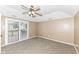 Carpeted bedroom with ceiling fan and sliding glass doors to deck at 2719 E 28Th St, Indianapolis, IN 46218