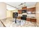 Kitchen with dark wood cabinets, granite countertops, and black appliances at 2719 E 28Th St, Indianapolis, IN 46218