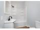 Clean bathroom with a white tub/shower combo at 906 N Parker Ave, Indianapolis, IN 46201