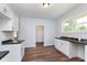 Modern kitchen featuring white cabinets and dark countertops at 906 N Parker Ave, Indianapolis, IN 46201