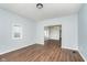 Living room with hardwood floors, large window and view of other rooms at 906 N Parker Ave, Indianapolis, IN 46201