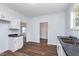 Renovated kitchen with white cabinets and dark countertops at 906 N Parker Ave, Indianapolis, IN 46201