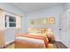 Cozy bedroom with light walls, a yellow headboard, and orange accents at 906 N Parker Ave, Indianapolis, IN 46201