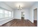 Dining room with hardwood floors, chandelier, and view of kitchen at 906 N Parker Ave, Indianapolis, IN 46201