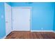 Bright bedroom with light blue walls, hardwood floors, and double door closet at 450 Kindig Rd, Indianapolis, IN 46217