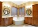 Spa-like bathroom with corner soaking tub and double vanities at 15482 Bridgewater Club Blvd, Carmel, IN 46033