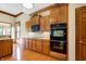 Kitchen with stainless steel appliances and wood cabinetry at 15482 Bridgewater Club Blvd, Carmel, IN 46033